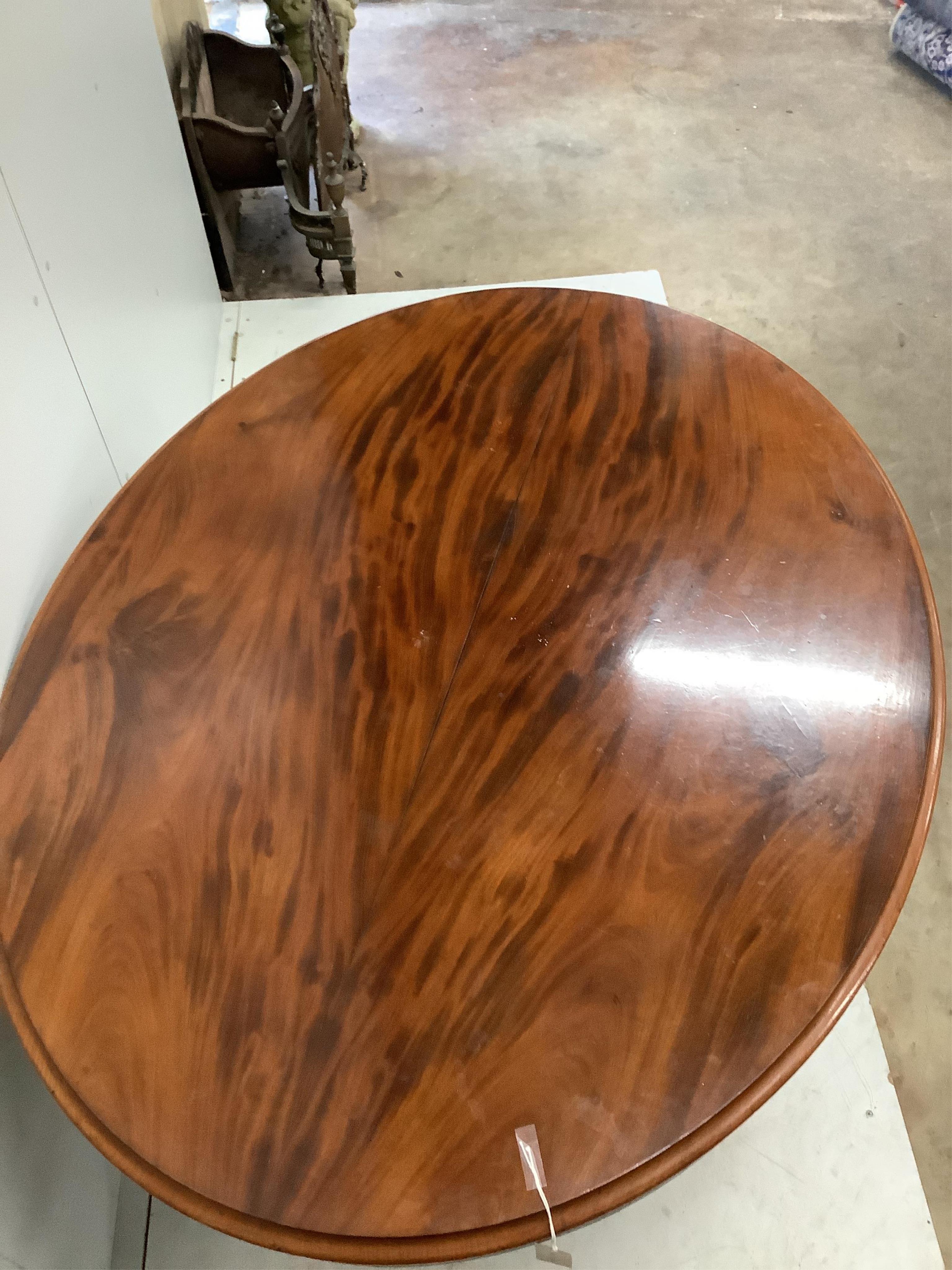 A Victorian oval mahogany tilt top loo table, diameter 146cm, depth 114cm, height 75cm. Condition - poor to fair